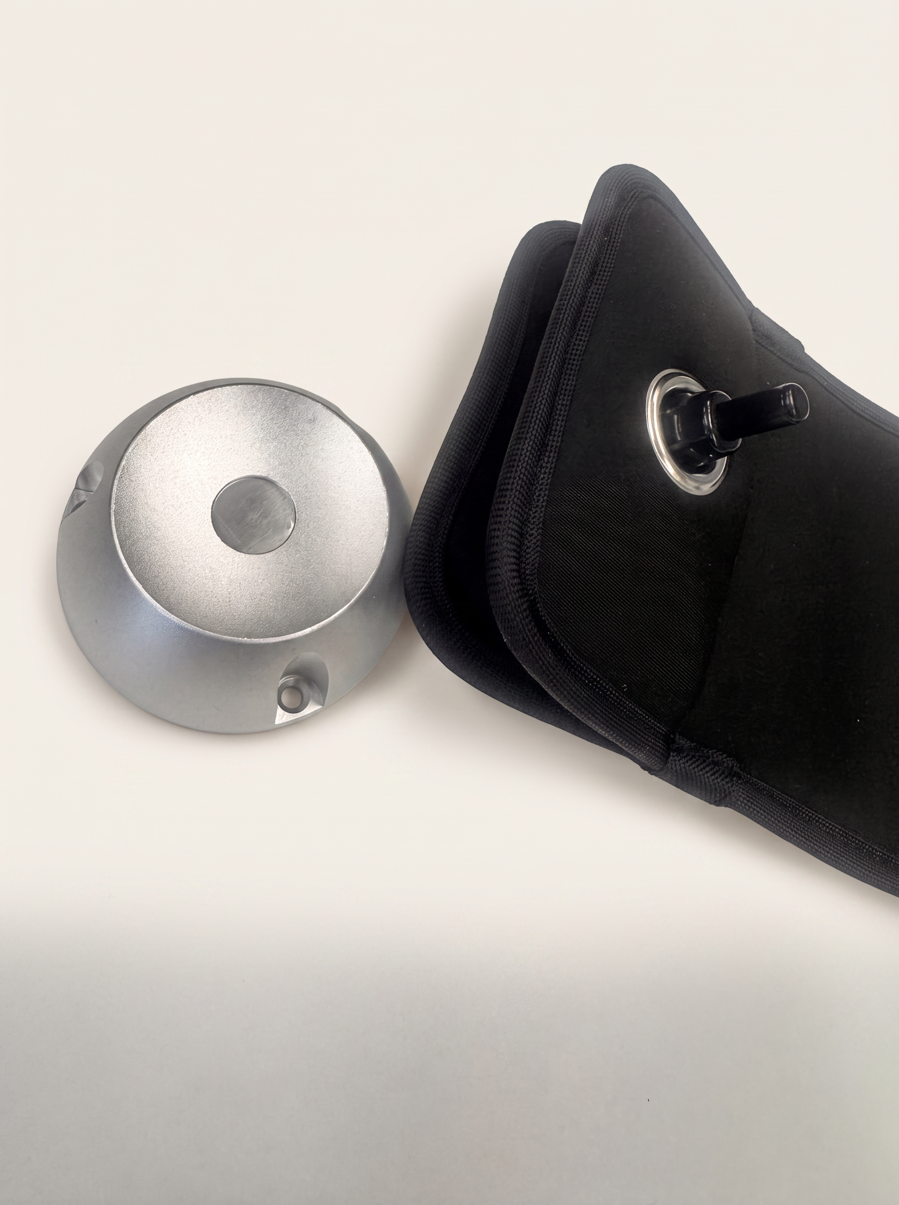 The machined aluminium TOVI unlocker beside an opened pouch.